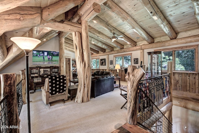 carpeted living area with wooden ceiling, vaulted ceiling with beams, and ceiling fan