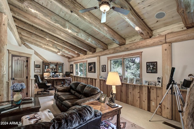 carpeted living area featuring lofted ceiling with beams, wooden walls, ceiling fan, and wooden ceiling