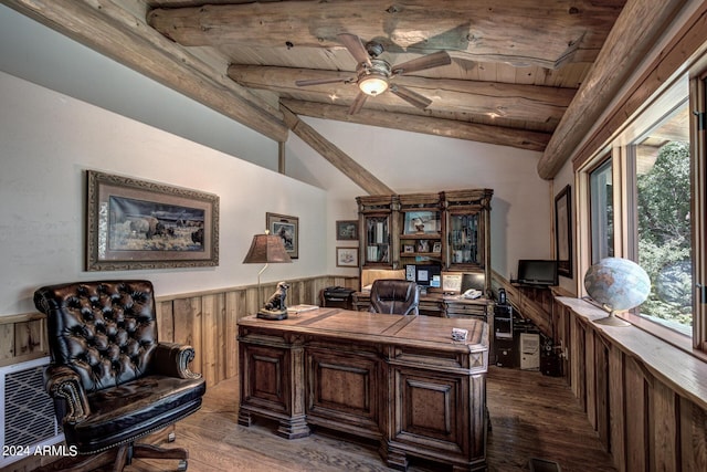 home office with plenty of natural light, wainscoting, lofted ceiling with beams, and wood walls