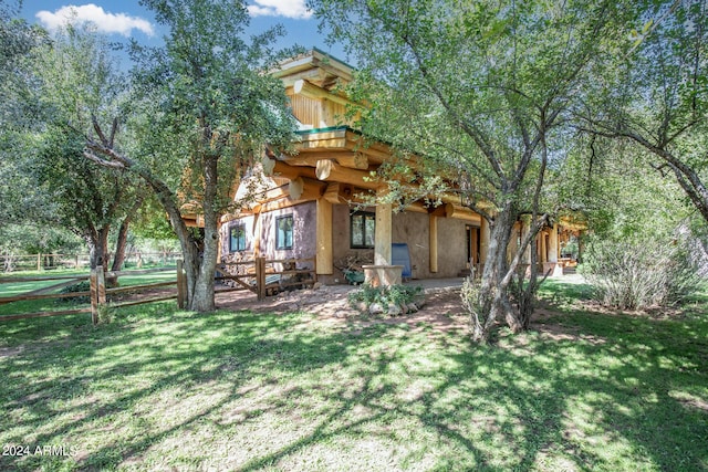 exterior space with a patio, a yard, fence, and stucco siding