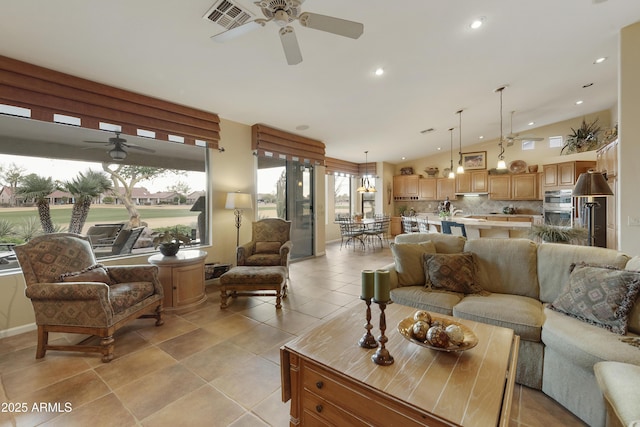 tiled living room with ceiling fan and vaulted ceiling