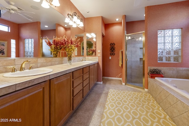 bathroom with tile patterned flooring, shower with separate bathtub, vanity, and decorative backsplash