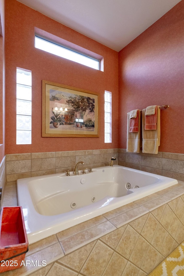 bathroom with a relaxing tiled tub