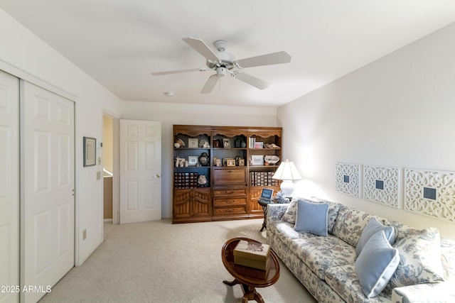 carpeted living room with ceiling fan