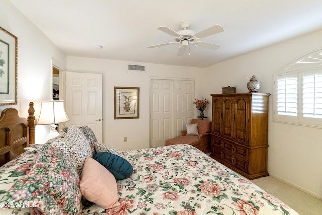 carpeted bedroom featuring a closet and ceiling fan