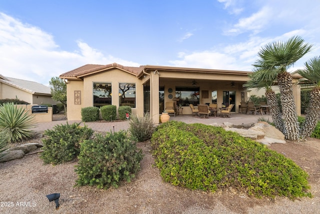 back of house featuring ceiling fan and a patio area