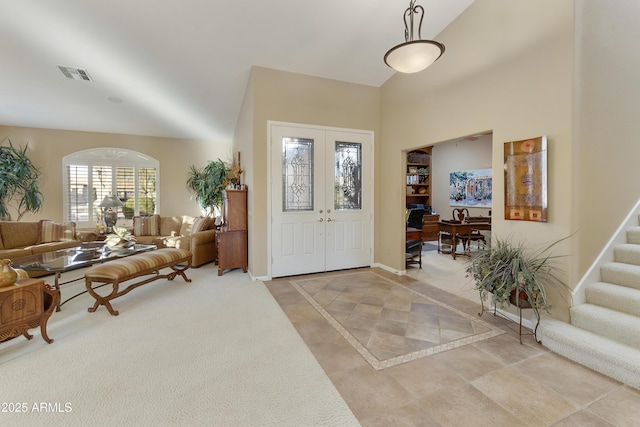 foyer with french doors and high vaulted ceiling