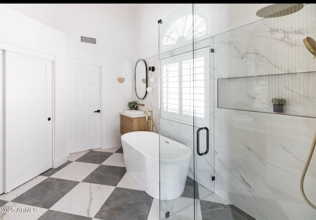 802 N Lisbon Dr, Chandler, AZ 85226 - full bath featuring a marble finish shower, vanity, healthy amount of natural light, a freestanding tub, and a towering ceiling
