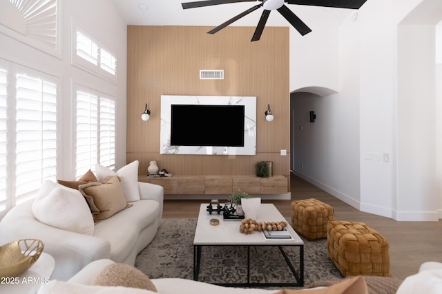 802 N Lisbon Dr, Chandler, AZ 85226 - living area featuring arched walkways, ceiling fan, a high ceiling, baseboards, and wood finished floors