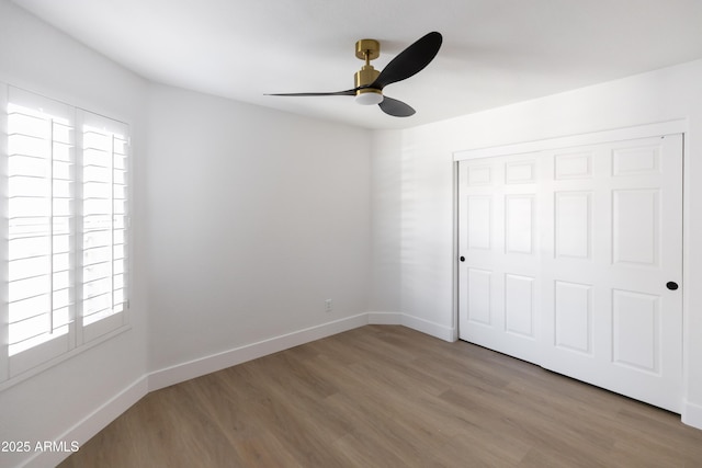 802 N Lisbon Dr, Chandler, AZ 85226 - unfurnished bedroom featuring multiple windows, wood finished floors, a closet, and baseboards