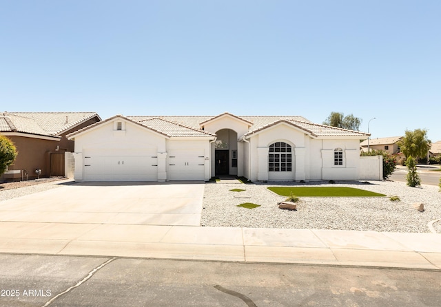 802 N Lisbon Dr, Chandler, AZ 85226 - mediterranean / spanish-style house featuring stucco siding, a garage, a tiled roof, and concrete driveway