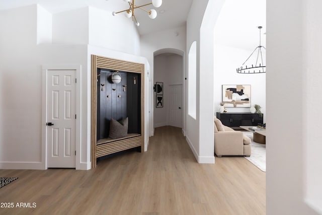 802 N Lisbon Dr, Chandler, AZ 85226 - hall featuring a chandelier, arched walkways, light wood-style flooring, elevator, and high vaulted ceiling