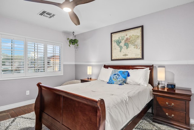 bedroom featuring wood finished floors, baseboards, ceiling fan, and visible vents