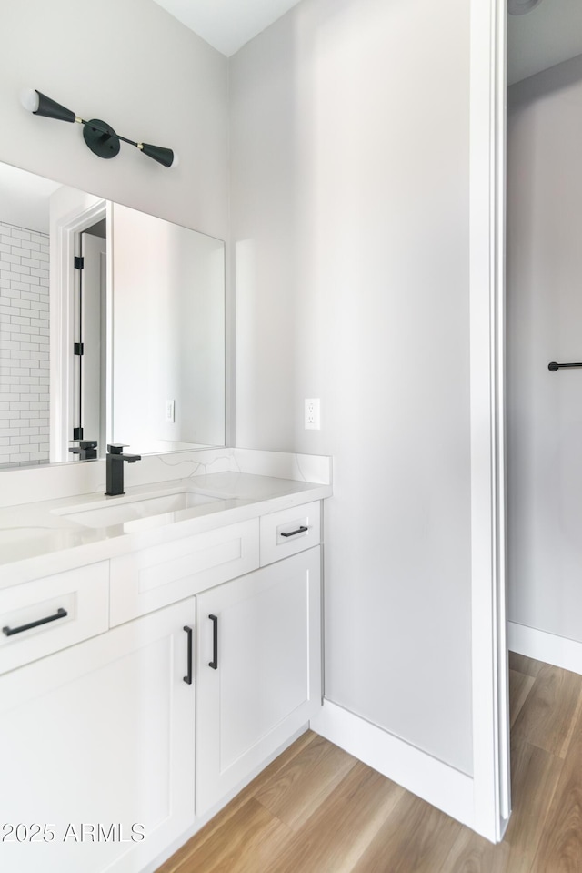 bathroom featuring vanity and wood-type flooring