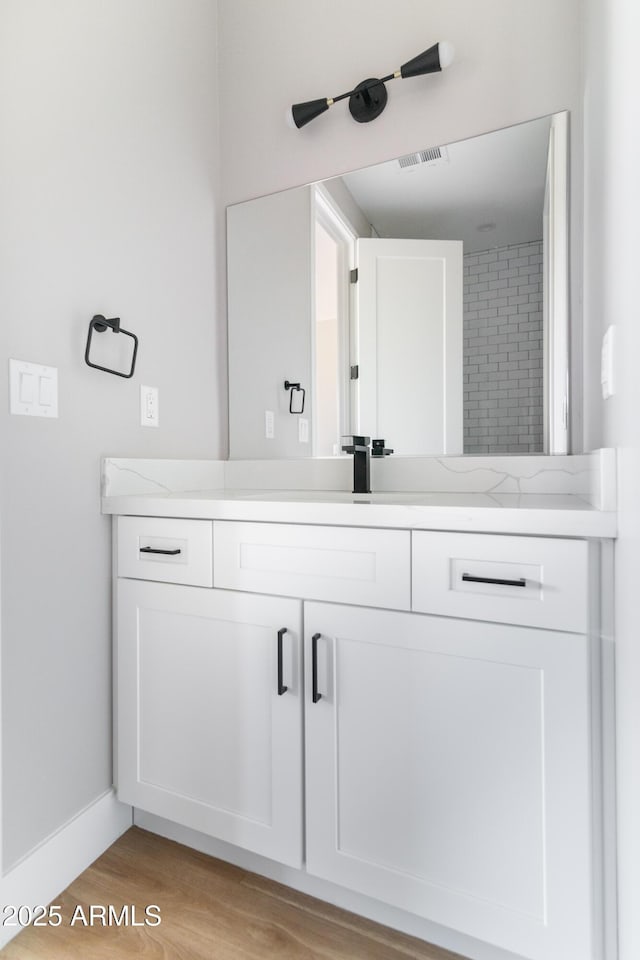 bathroom with vanity and hardwood / wood-style flooring