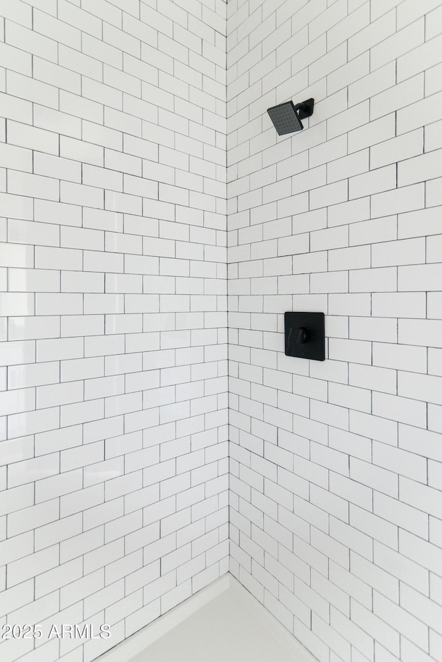 bathroom with tiled shower