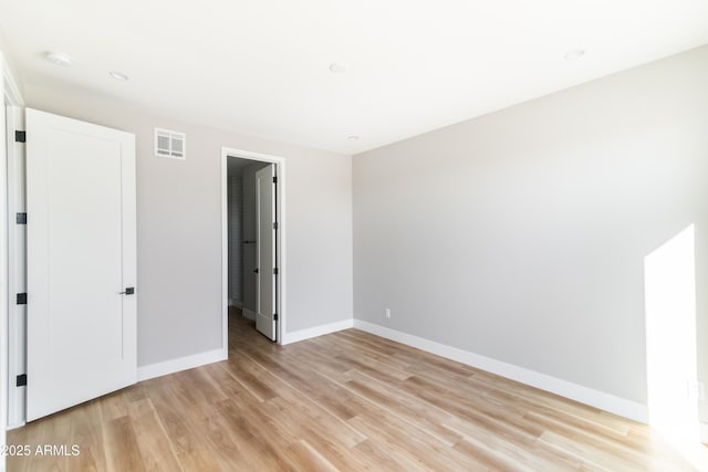 spare room featuring light wood-type flooring