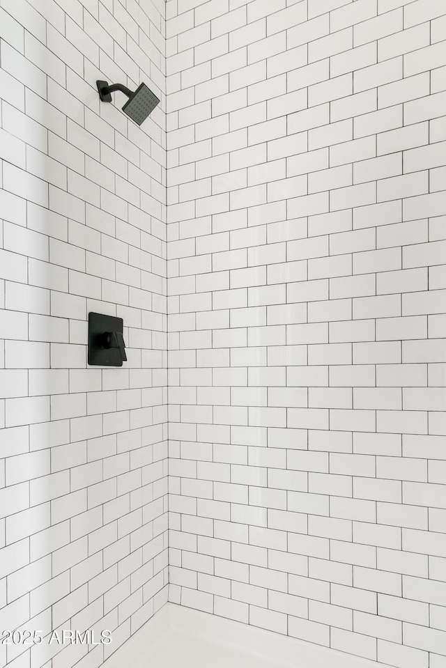 bathroom with tiled shower