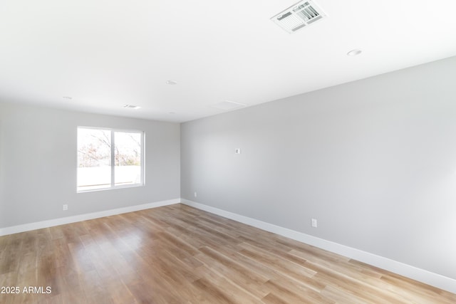 spare room featuring light wood-type flooring