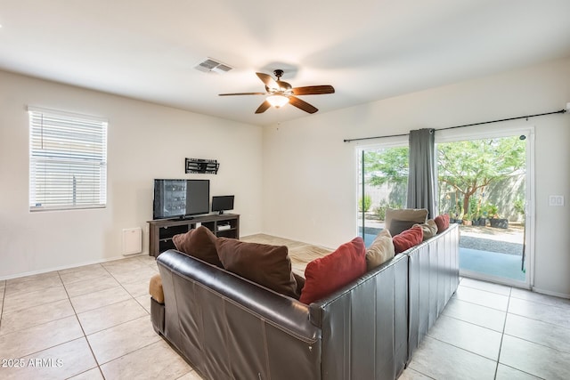 1718 W Cameron Blvd, Coolidge, AZ 85128 - living area featuring light tile patterned floors, ceiling fan, and baseboards