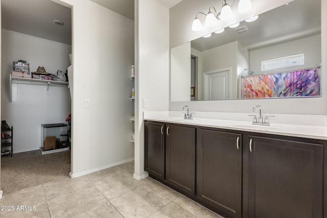 1718 W Cameron Blvd, Coolidge, AZ 85128 - bathroom with double vanity, tile patterned flooring, and baseboards