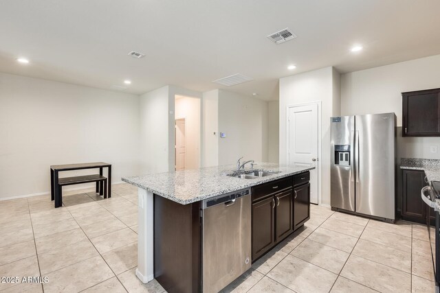 1718 W Cameron Blvd, Coolidge, AZ 85128 - kitchen featuring appliances with stainless steel finishes, a sink, an island with sink, light stone countertops, and light tile patterned flooring
