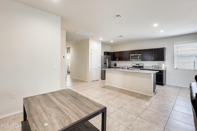 1718 W Cameron Blvd, Coolidge, AZ 85128 - kitchen featuring stainless steel appliances, recessed lighting, light tile patterned floors, a kitchen island with sink, and a sink