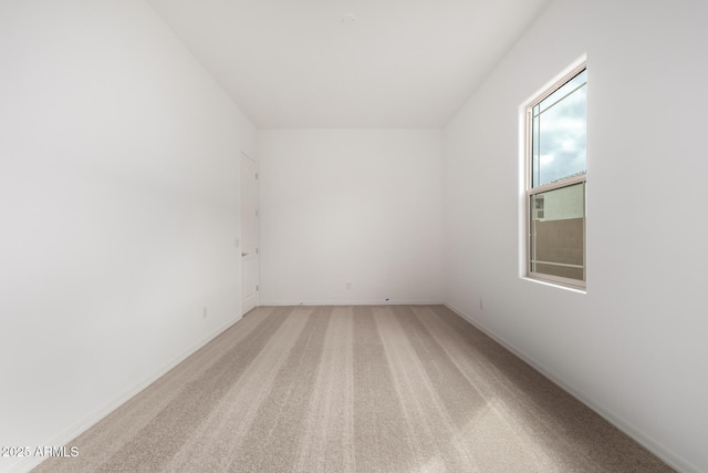 unfurnished room with light carpet