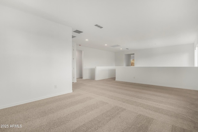 unfurnished room featuring recessed lighting, visible vents, light colored carpet, and baseboards