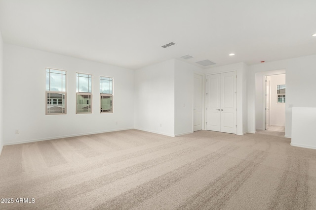 empty room featuring recessed lighting, baseboards, visible vents, and light carpet