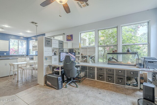 office with a sink, ceiling fan, healthy amount of natural light, and light tile patterned floors
