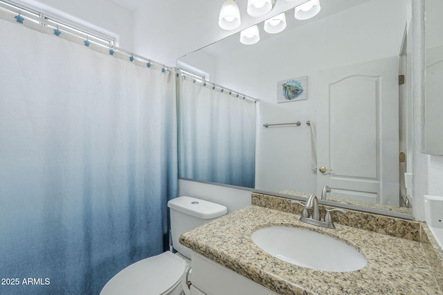 full bathroom with toilet, vanity, and a shower with curtain