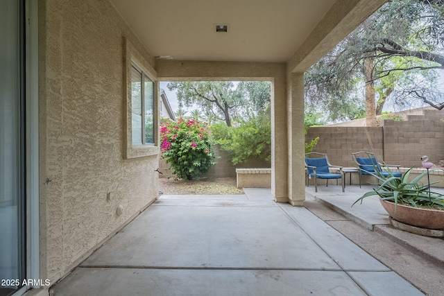 view of patio featuring fence
