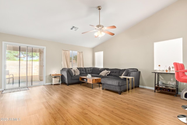 living room featuring light wood-type flooring, vaulted ceiling, and ceiling fan