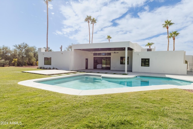 view of swimming pool with a lawn and a patio area