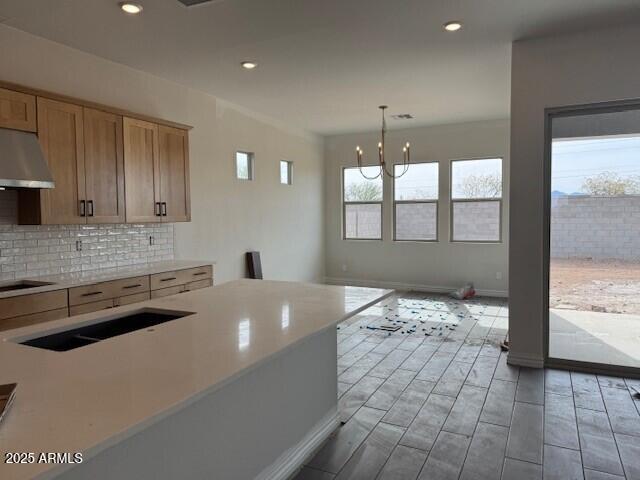 10039 W Verde Ln, Avondale, AZ 85392 - kitchen featuring wood finish floors, under cabinet range hood, backsplash, recessed lighting, and light countertops