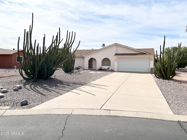 view of front of property featuring driveway, a garage, and brick siding