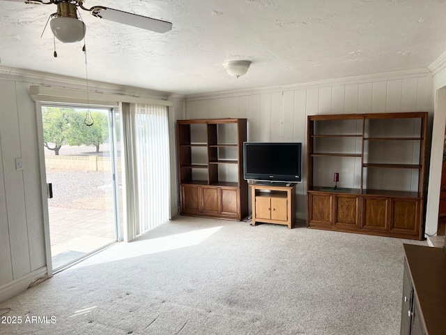 unfurnished living room featuring a ceiling fan, light colored carpet, and a textured ceiling