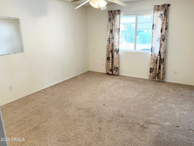 empty room with ceiling fan and carpet flooring