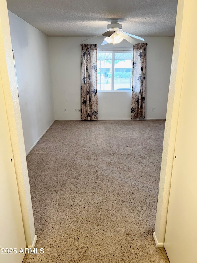 spare room with ceiling fan and a textured ceiling