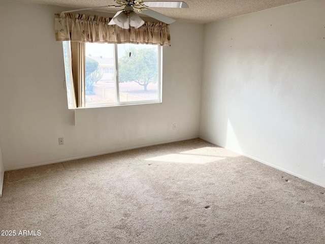 unfurnished room with a textured ceiling, carpet floors, and a ceiling fan