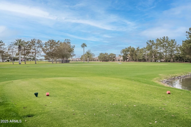 surrounding community featuring view of golf course and a lawn