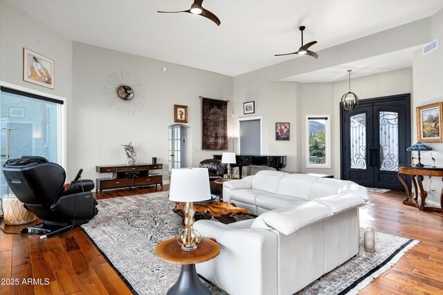 living room featuring visible vents, a ceiling fan, hardwood / wood-style floors, and french doors