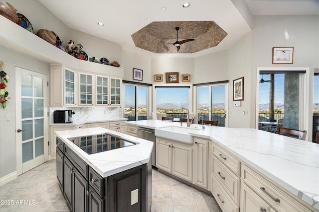 kitchen with a ceiling fan, black electric stovetop, a sink, and stainless steel dishwasher