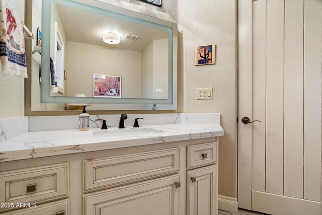 bathroom featuring visible vents and vanity