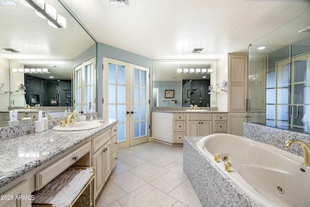 full bathroom with tile patterned flooring, visible vents, a sink, and french doors