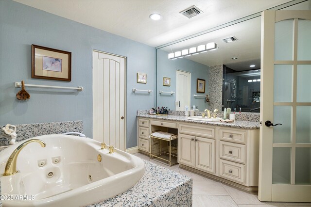 full bath with vanity, a tub with jets, tile patterned flooring, and visible vents