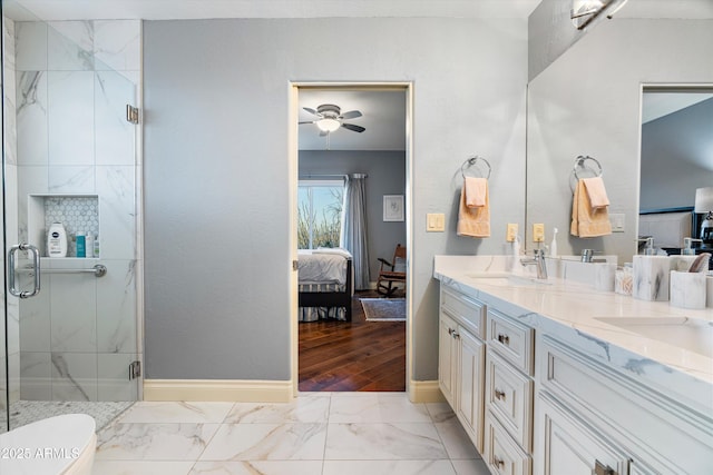 ensuite bathroom featuring connected bathroom, a sink, marble finish floor, a marble finish shower, and double vanity