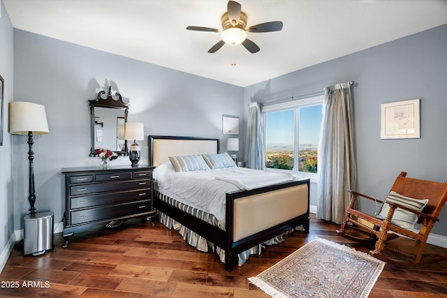 bedroom featuring a ceiling fan, baseboards, and dark wood-type flooring