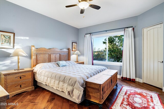 bedroom featuring ceiling fan, baseboards, and dark wood-type flooring